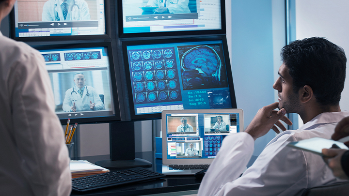 Doctor looking at computer screens