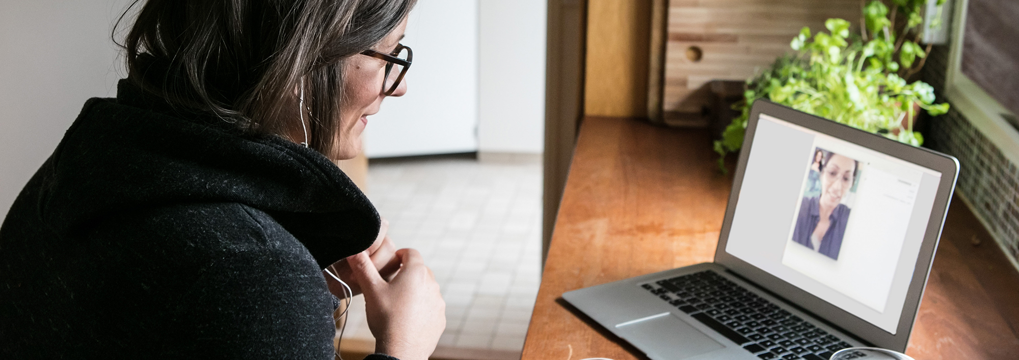 Woman video chatting on a laptop