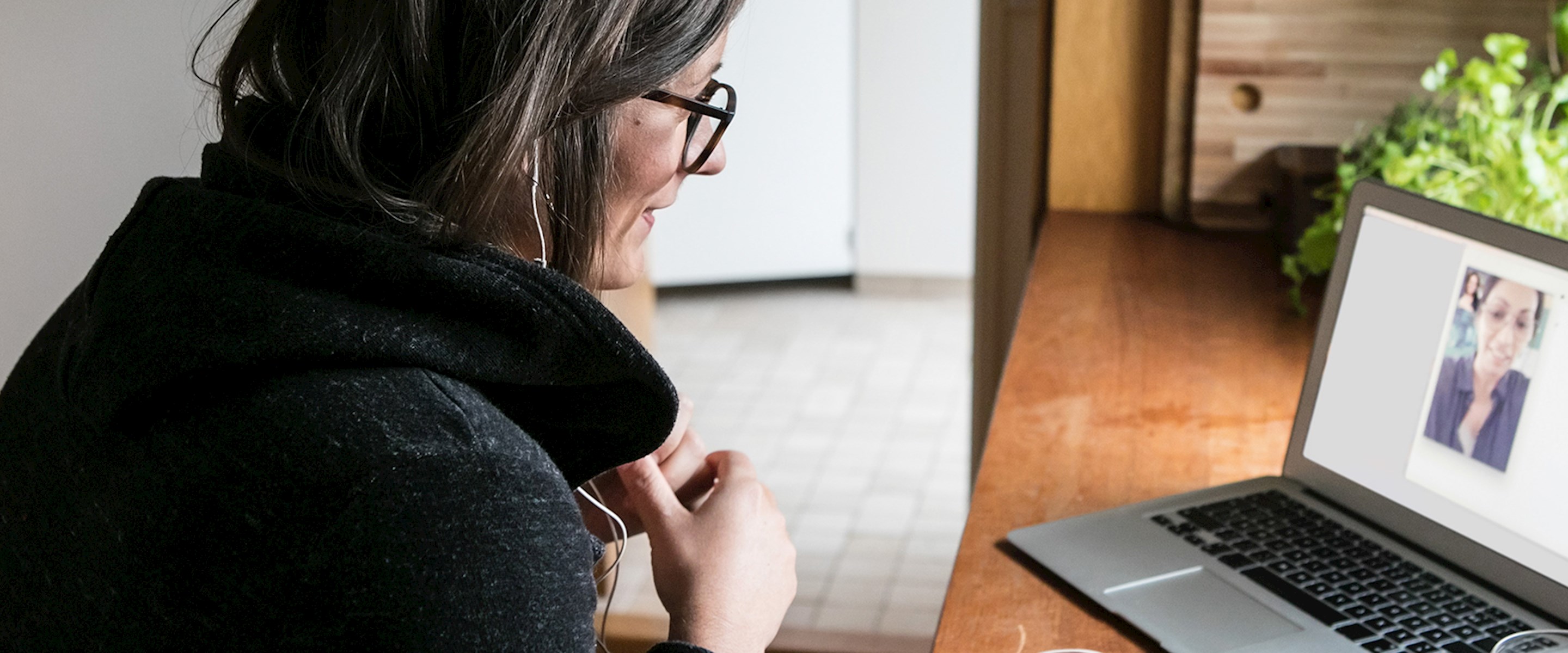 Woman video chatting on a laptop