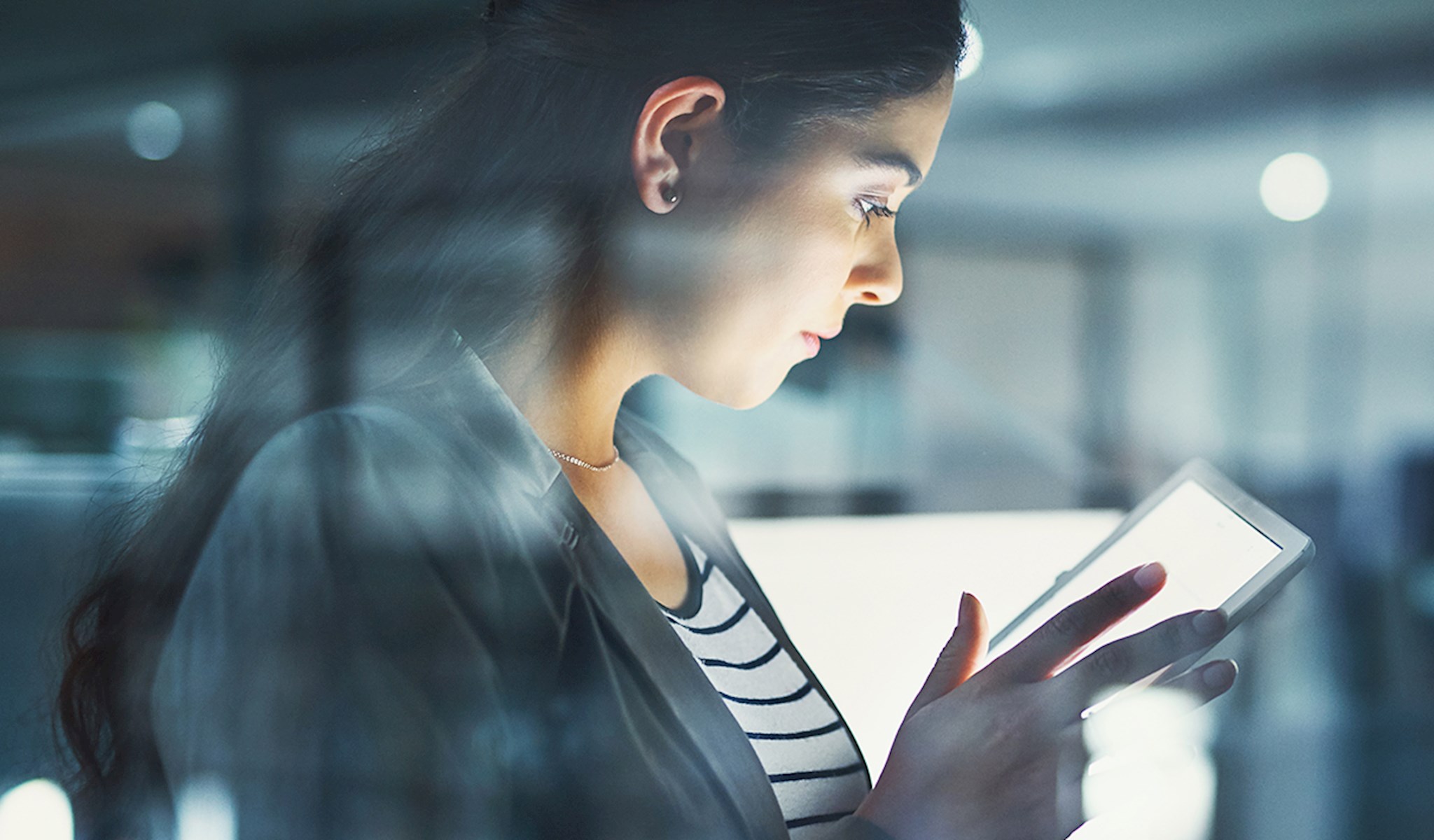 Woman in an office reading a tablet