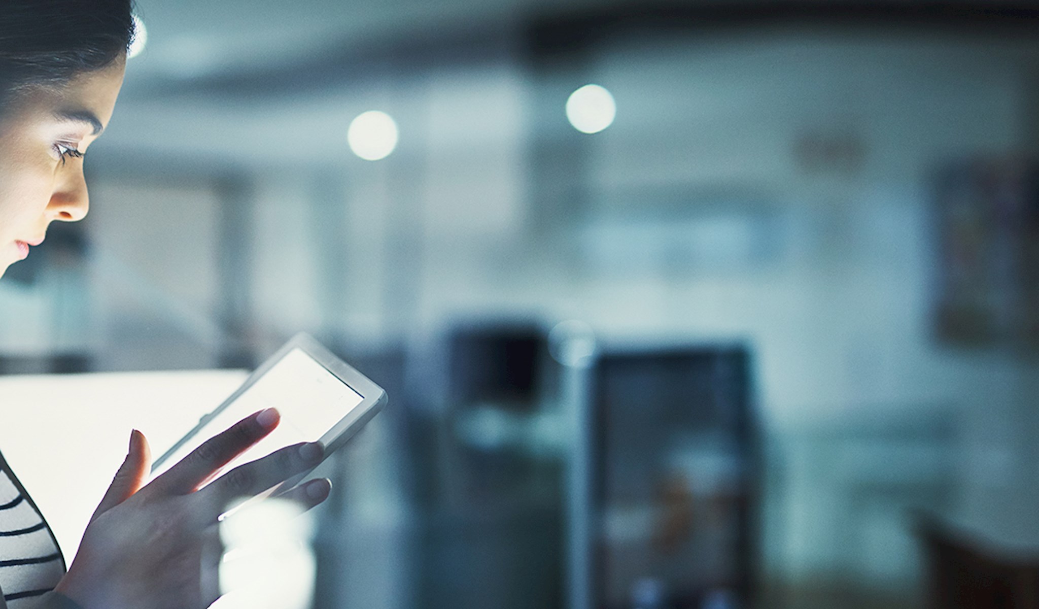 Woman in an office reading a tablet