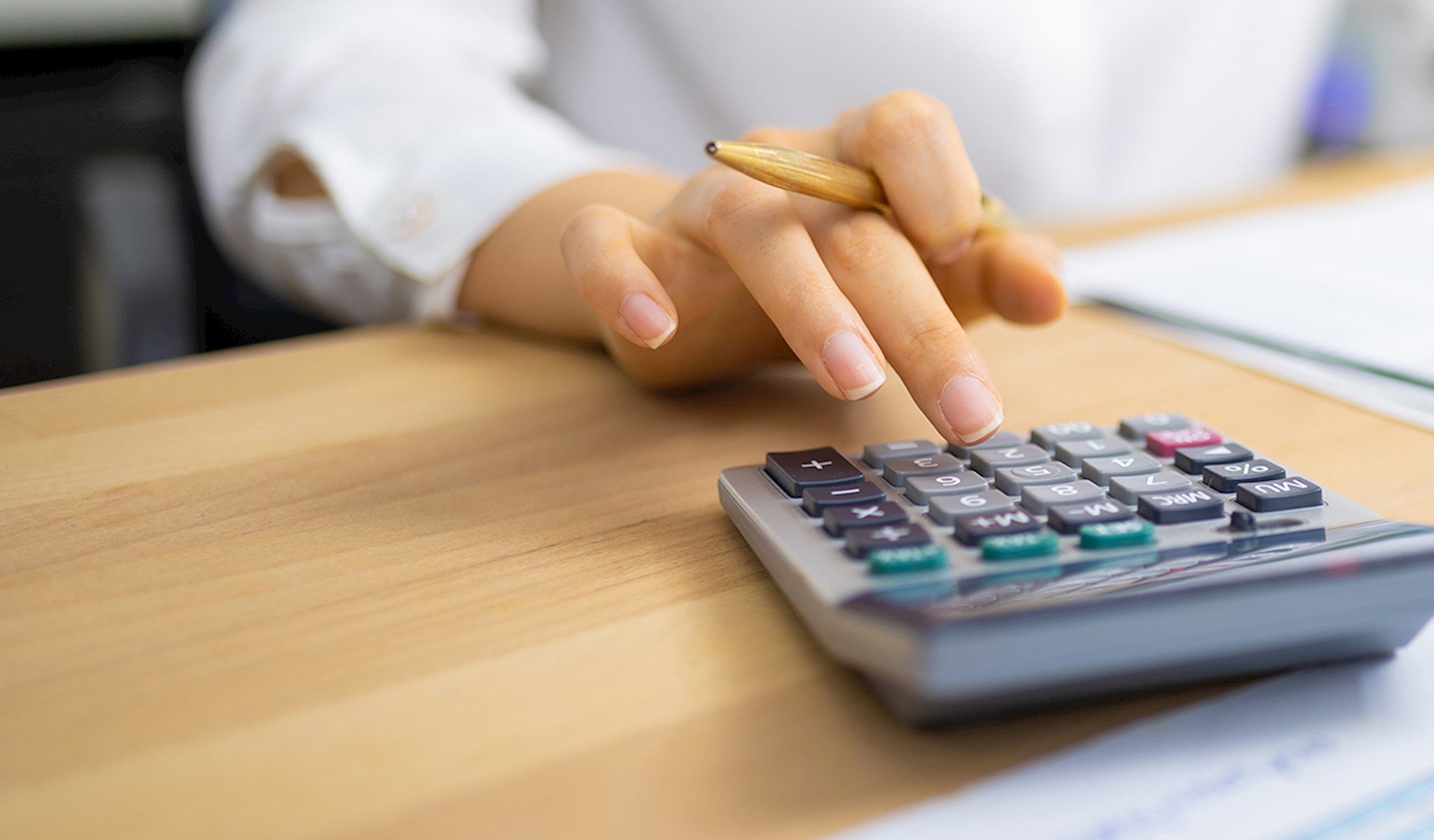 Woman's hand on a calculator