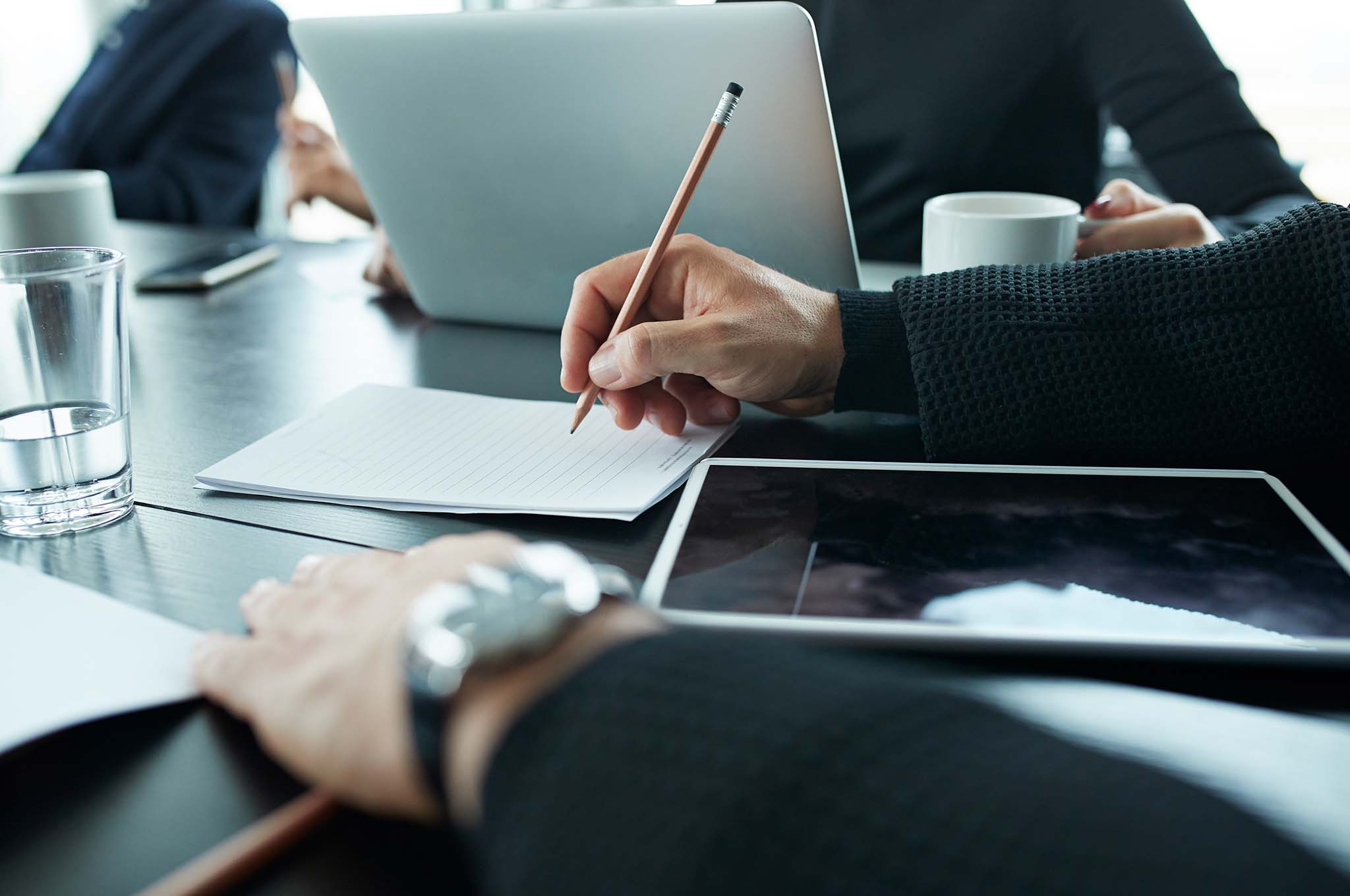 Hands on a desk with a tablet