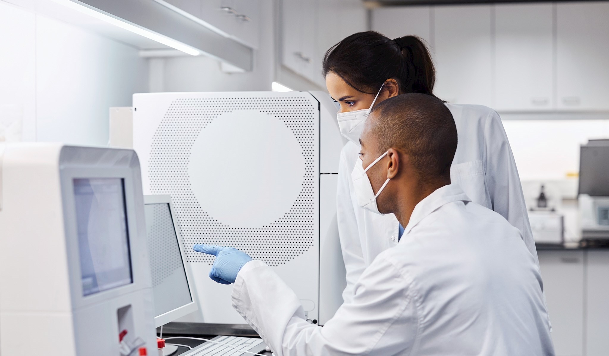 Medical technicians looking at a computer screen