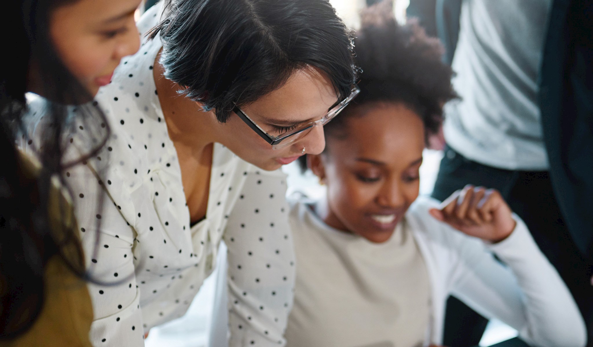 Woman looking over a girl's shoulder