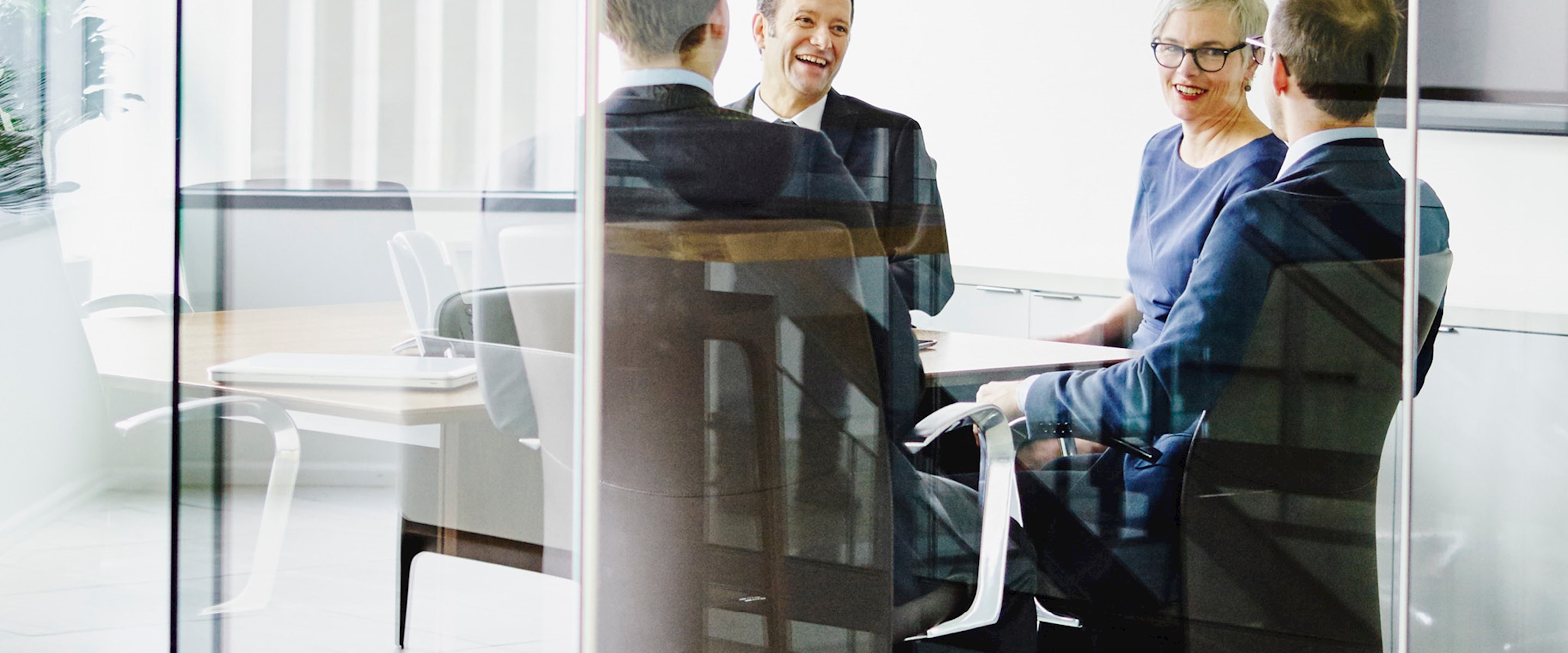 People sitting at a table in a conference room