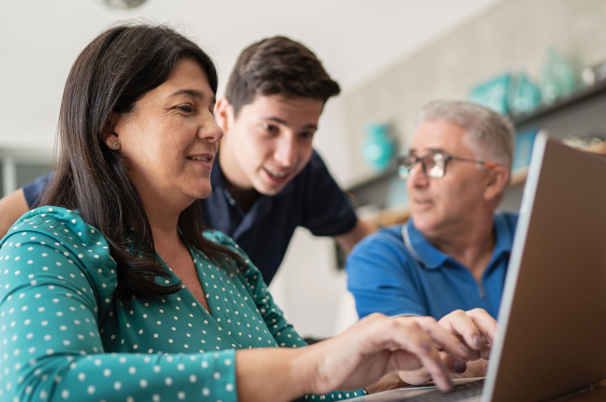 Parents and their son looking at a laptop