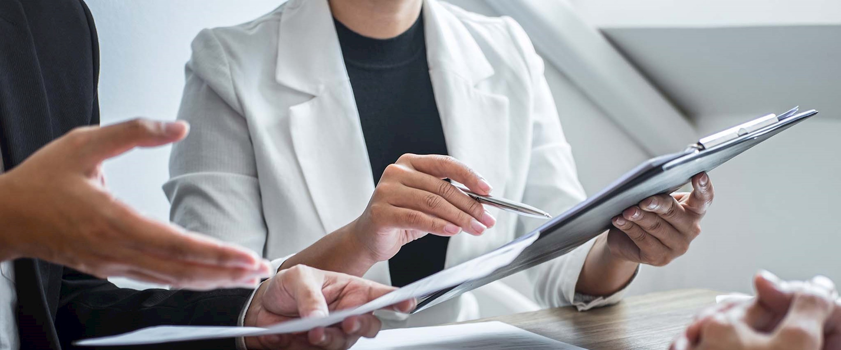 Close up of people looking at some papers