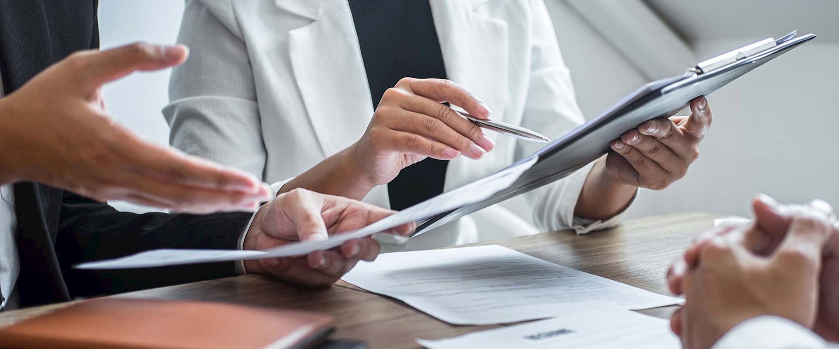 Close up of people looking at some papers