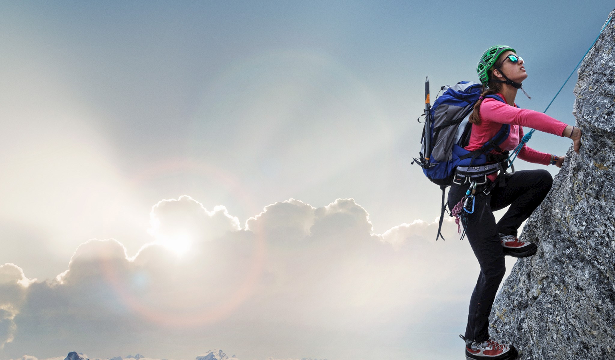 Woman rock climbing in the mountains