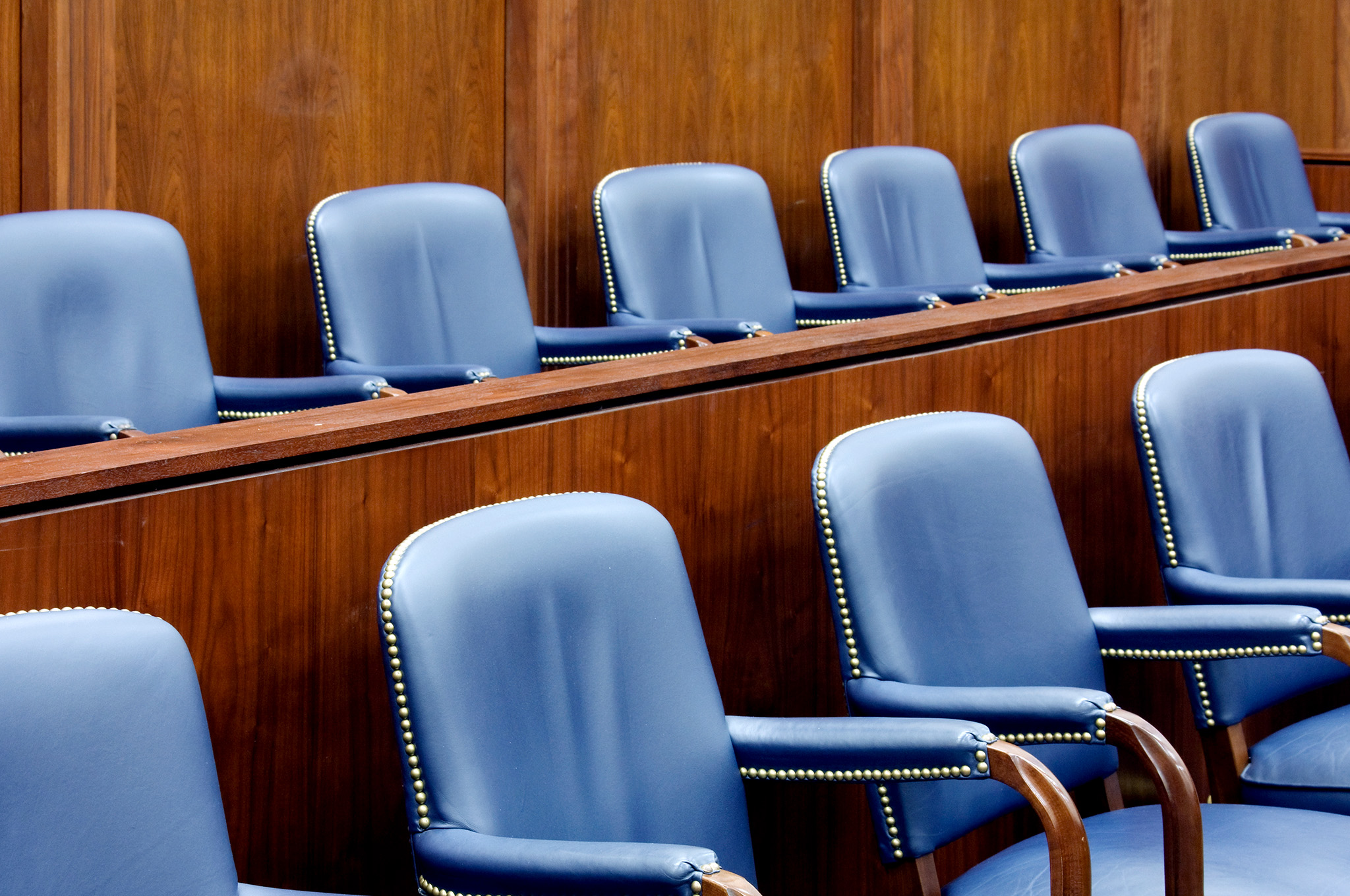 An image of empty chairs in a courtroom setting