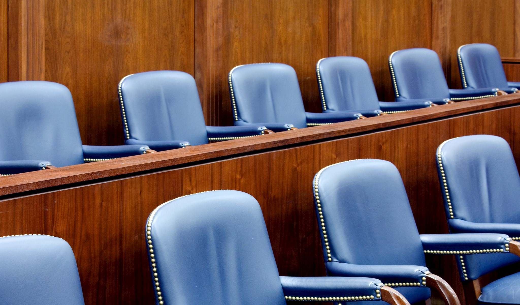 An image of empty chairs in a courtroom setting